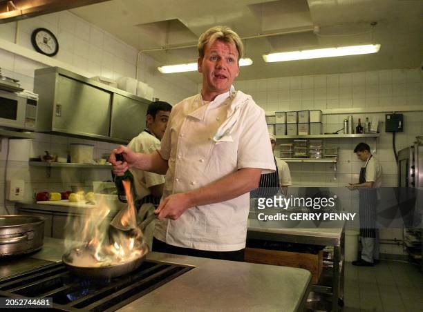 British Chef Gordon Ramsey shouts instructions from his kitchen at his Chelsea restaurant 19 January 2001, after being awarded three stars in...