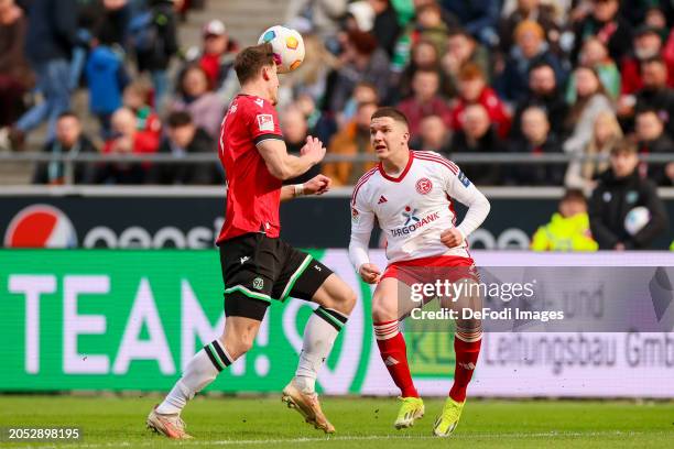 Phil Neumann of Hannover 96 and Christos Tzolis of Fortuna Duesseldorf battle for the ball during the Second Bundesliga match between Hannover 96 and...