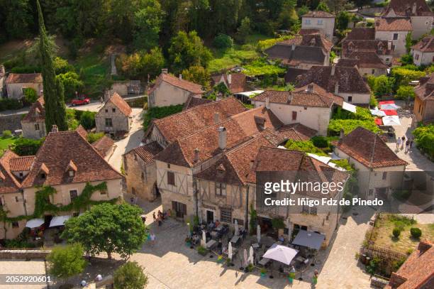 people relaxing in saint-cirq lapopie medieval village, lot valley, occitanie, france. - france countryside stock pictures, royalty-free photos & images