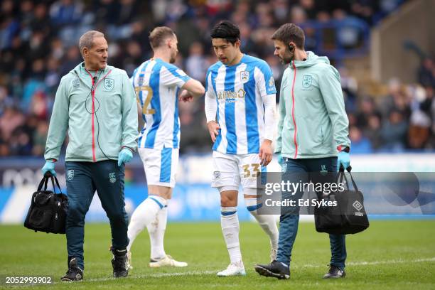 Yuta Nakayama of Huddersfield Town leaves the field after receiving medical treatment after picking up an injury during the Sky Bet Championship...