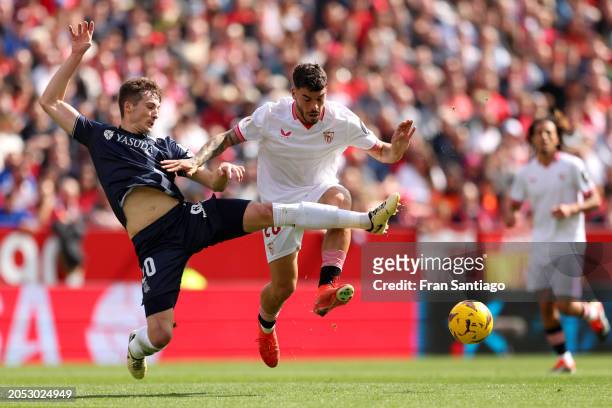Jon Pacheco of Real Sociedad battles for possession with Isaac Romero of Sevilla FC during the LaLiga EA Sports match between Sevilla FC and Real...