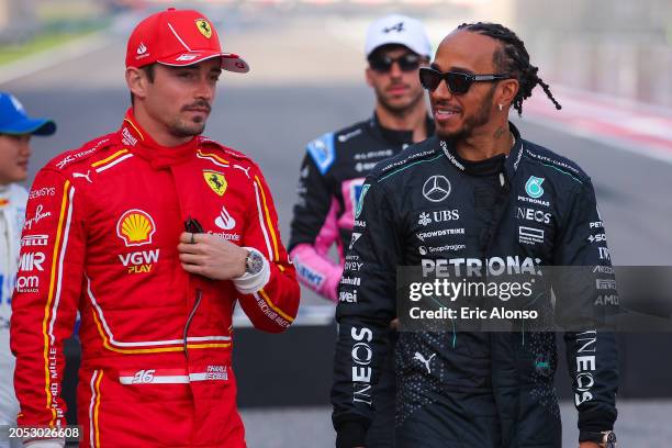 Lewis Hamilton of Great Britain and Mercedes speaks with Charles Leclerc of Moanco and Scuderia Ferrari during the F1 Grand Prix of Bahrain at...