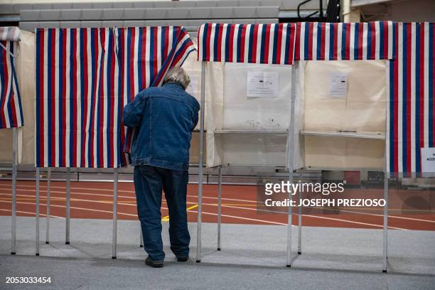 Person votes in the US Presidential primary on Super Tuesday at Gloucester High School in Gloucester, Massachusetts, on March 5, 2024. Americans from...