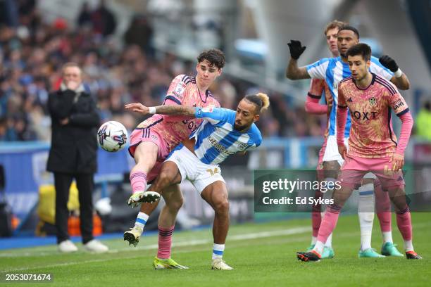 Sorba Thomas of Huddersfield Town is challenged by Archie Gray of Leeds United during the Sky Bet Championship match between Huddersfield Town and...