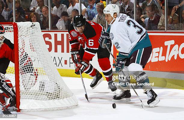 Tommy Albelin of the New Jersey Devils tries to steal the puck from Steve Thomas of the Mighty Ducks of Anaheim in game three of the 2003 Stanley Cup...