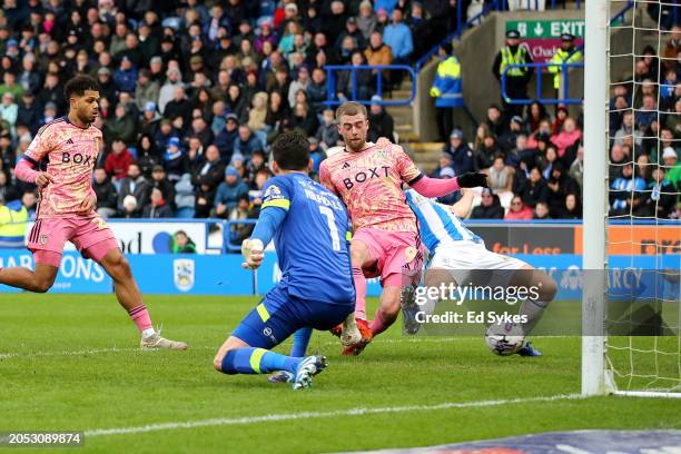 Patrick Bamford of Leeds United scores his team's first goal as Lee Nicholls of Huddersfield Town fails to make a save during the Sky Bet...