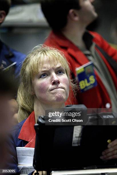 Trader Christine Lopau ponders her next move in the IBM stock options pit at the Chicago Board of Options Exchange in Chicago, Illinois June 3, 2003....