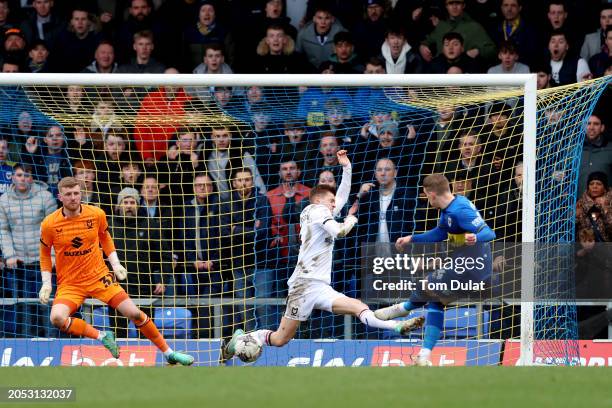 Ronan Curtis of AFC Wimbledon scores his team's first goal as Michael Kelly of Milton Keynes Dons fails to make a save during the Sky Bet League Two...