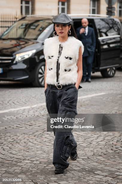 Yoyo Cao wears white fur vest, black cargo jeans, black leather beret, outside Giambattista Valli, during the Womenswear Fall/Winter 2024/2025 as...