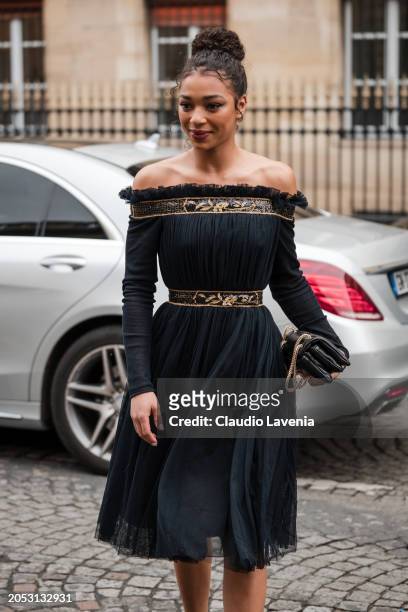 Manon Bresch wears black off the shoulders mini dress with gold details, outside Giambattista Valli, during the Womenswear Fall/Winter 2024/2025 as...