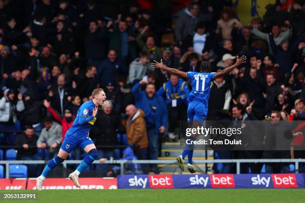 Ronan Curtis of AFC Wimbledon celebrates scoring his team's first goal with teammates Josh Neufville during the Sky Bet League Two match between AFC...