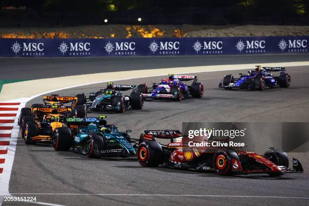 Carlos Sainz of Spain driving the Ferrari SF-24 leads Fernando Alonso of Spain driving the Aston Martin AMR24 Mercedes during the F1 Grand Prix of...