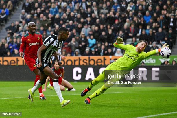 Alexander Isak of Newcastle United scores his team's first goal as Jose Sa of Wolverhampton Wanderers fails to make a save during the Premier League...
