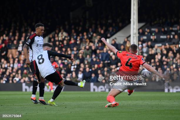 Harry Wilson of Fulham scores his team's first goal whilst under pressure from Adam Webster of Brighton & Hove Albion during the Premier League match...