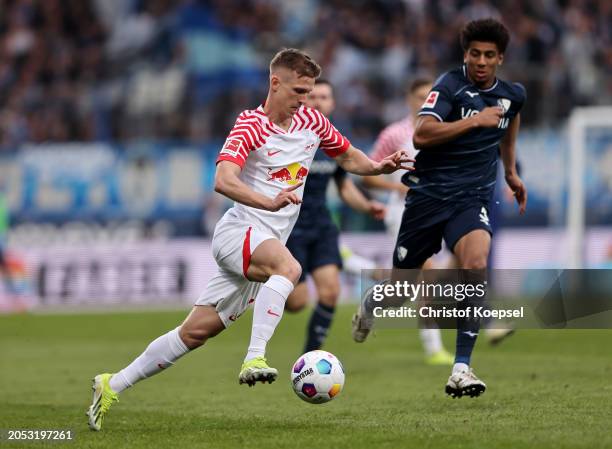 Dani Olmo of RB Leipzig runs with the ball under pressure from Bernardo of VfL Bochum during the Bundesliga match between VfL Bochum 1848 and RB...