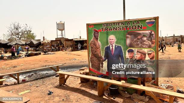 March 2024, Burkina Faso, Ouagadougou: Russia's President Putin and Burkina Faso's interim military president Traoré can be seen together on a poster...