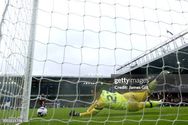 Alphonse Areola of West Ham United saves the penalty kick from Beto of Everton, after a VAR Review confirmed a handball incident by Kurt Zouma of...