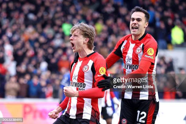 Mads Roerslev of Brentford celebrates scoring his team's first goal with team mate Sergio Reguilon during the Premier League match between Brentford...