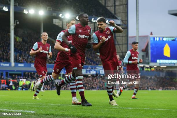 Kurt Zouma of West Ham United celebrates scoring his team's first goal with teammate Lucas Paqueta during the Premier League match between Everton FC...