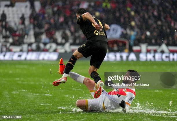 Robert Navarro of Cadiz CF is challenged by Unai Lopez of Rayo Vallecano amidst a hail storm during the LaLiga EA Sports match between Rayo Vallecano...