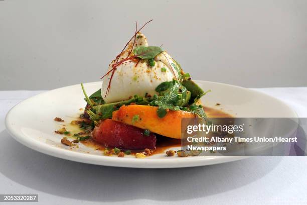 Maple Brook Farms Buratta with marinated peaches, avocados, wild arugula, toasted pistachios and lemon-lime honey dressing at 15 Church restaurant on...