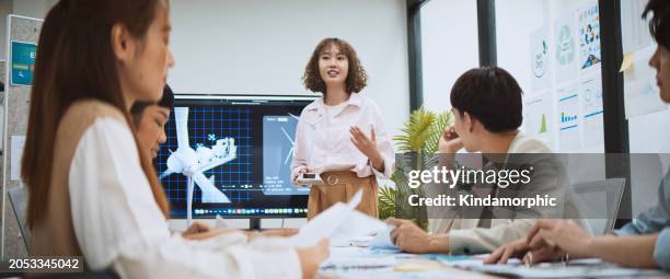 asian business people team brainstorm meeting in sustainable corporate office. presentation esg project planning, wind turbine power energy generation. environmental conservation, responsible business - group video conference stock pictures, royalty-free photos & images