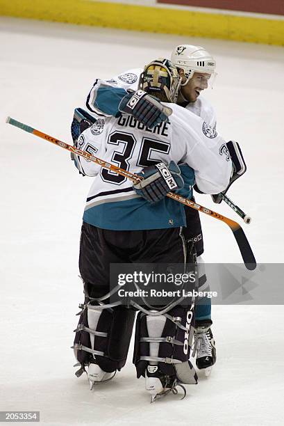 Marc Chouinard the Mighty Ducks of Anaheim congratulates Jean-Sebastien Giguere after an overtime victory over the New Jersey Devils in game three of...