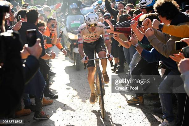 Race winner Tadej Pogacar of Slovenia and UAE Team Emirates competes while fans cheer during the 18th Strade Bianche 2024, Men's Elite a 215km one...