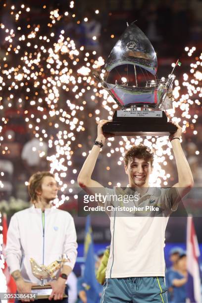 Ugo Humbert of France celebrates victory with the trophy over Alexander Bublik of Kazakhstan in the final match during the Dubai Duty Free Tennis...