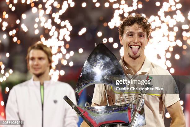 Ugo Humbert of France celebrates victory with the trophy over Alexander Bublik of Kazakhstan in the final match during the Dubai Duty Free Tennis...