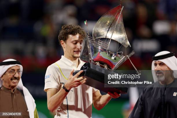 Ugo Humbert of France celebrates victory with the trophy over Alexander Bublik of Kazakhstan in the final match during the Dubai Duty Free Tennis...