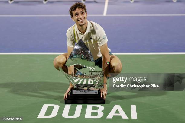 Ugo Humbert of France celebrates victory with the trophy over Alexander Bublik of Kazakhstan in the final match during the Dubai Duty Free Tennis...