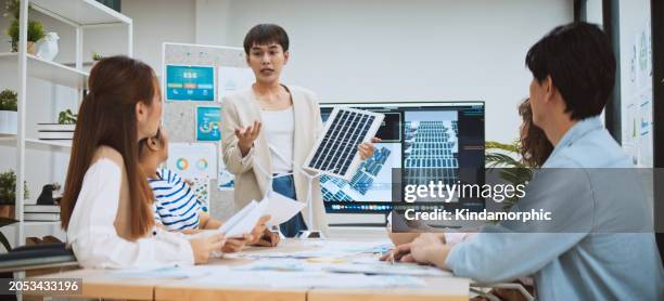 asian business people team brainstorm meeting in sustainable corporate office. presentation esg project planning, solar panel, wind turbine power energy generation. environmental conservation concept - group video conference stock pictures, royalty-free photos & images