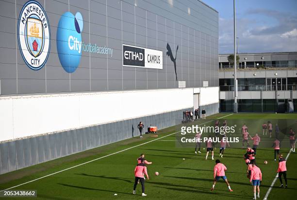 Players attend a team training session at Manchester City's training ground in north-west England on March 5 on the eve of their UEFA Champions...