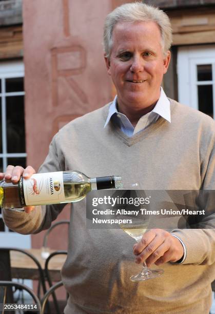 Wine importer Tony O'Haire pours a glass of Aragosta Vermentino di Sardegna from Italy at Lucas Confectionery on Monday, Oct. 5, 2015 in Troy, N.Y.