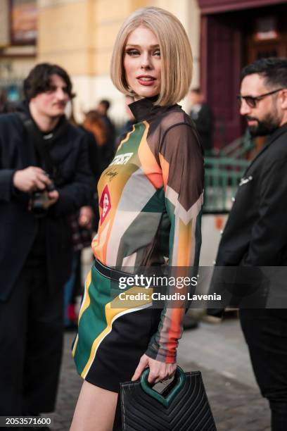 Coco Rocha wears printed Casablanca sheer turtleneck top, black, yellow and green mini skirt, black bag, outside Casablanca, during the Womenswear...