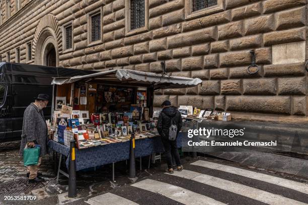 Two men stand and snoop at a second hand books stall in front of Palazzo Strozzi on March 02, 2024 in Florence, Italy. The historic centre of...