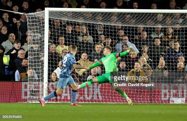 Lucas Digne of Aston Villa scores his team's third goal past Thomas Kaminski of Luton Town during the Premier League match between Luton Town and...