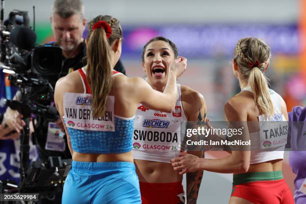 Ewa Swoboda of Team Poland is congratulated by Patrizia Van Der Weken of Team Luxembourg after competing in Heat 1 of the Women's 60 Metres...