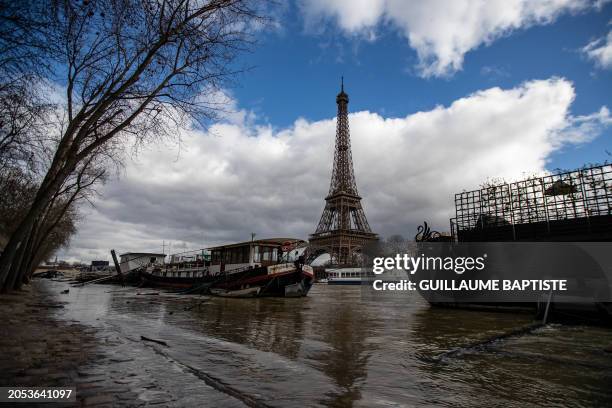 The Eiffel Tower appears between boats, as the river Seine floods the banks in Paris on March 5, 2024.