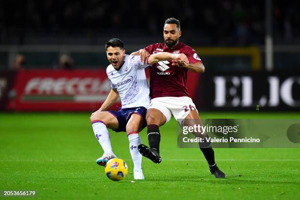 Riccardo Sottil of ACF Fiorentina is challenged by Koffi Djidji of Torino FC during the Serie A TIM match between Torino FC and ACF Fiorentina at...