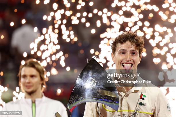 Ugo Humbert of France celebrates victory with the trophy over Alexander Bublik of Kazakhstan in the final match during the Dubai Duty Free Tennis...