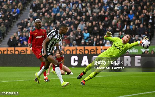 Newcastle United player Alexander Isak scores the first Newcastle goal past the despairing dive of Wolves goalkeeper Jose Sa during the Premier...