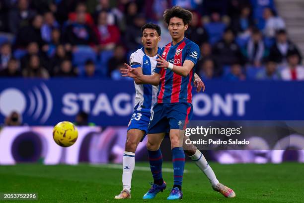 Omar El Hilali of RCD Espanyol competes for the ball with Kento Hashimoto of SD Huesca during the LaLiga Hypermotion match between RCD Espanyol and...