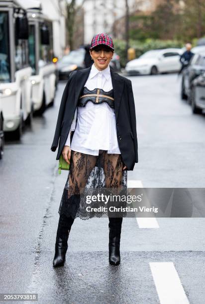 Salome Chaboki wears black laced transparent skirt Plakinger, black cowboy boots Guess, white oversized shirt Eliteé, leather top Rebekka Ruétz,...