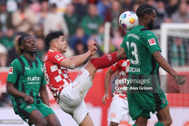 Nadiem Amiri of Mainz is challenged by Jordan Siebatcheu of Borussia Moenchengladbach during the Bundesliga match between 1. FSV Mainz 05 and...