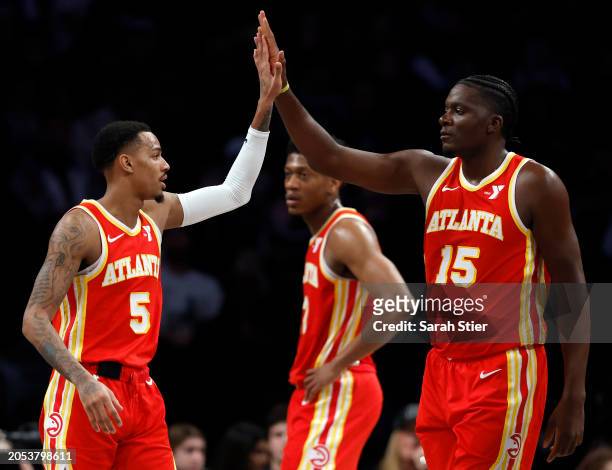 Dejounte Murray reacts with Clint Capela of the Atlanta Hawks during the first half against the Brooklyn Nets at Barclays Center on March 02, 2024 in...