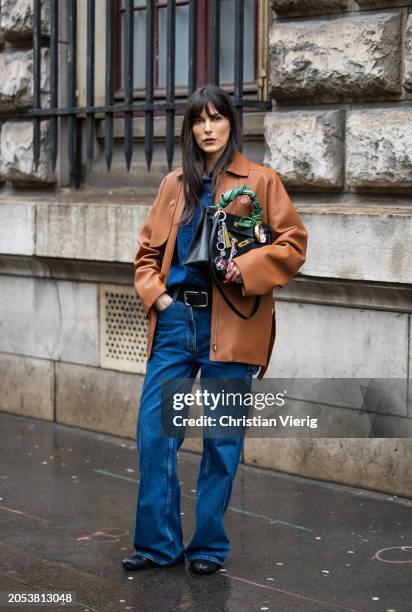 Leia Sfez wears black bag, brown jacket, denim shirt, belt, jeans outside Hermes during the Womenswear Fall/Winter 2024/2025 as part of Paris Fashion...