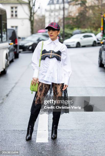 Salome Chaboki wears black laced transparent skirt Plakinger, black cowboy boots Guess, white oversized shirt Eliteé, leather top Rebekka Ruétz,...