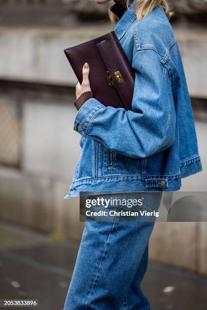 Helena Bordon wears burgundy bag, denim jacket, jeans, brown turtleneck outside Hermes during the Womenswear Fall/Winter 2024/2025 as part of Paris...